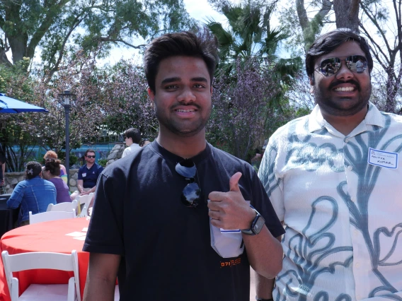 students in the TBG courtyard giving a thumbs up
