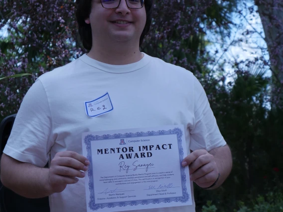 Rey displaying his certificate