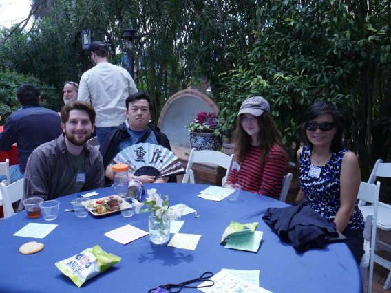 4 event attendees at a table with a blue cloth