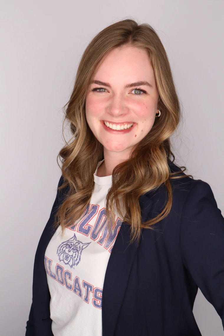 brenna in a navy balzer with a white ua teeshirt