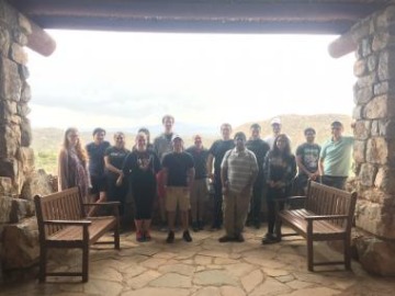 Group photo of students in a stone building